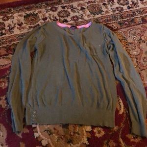 Green sweater with pink stitching